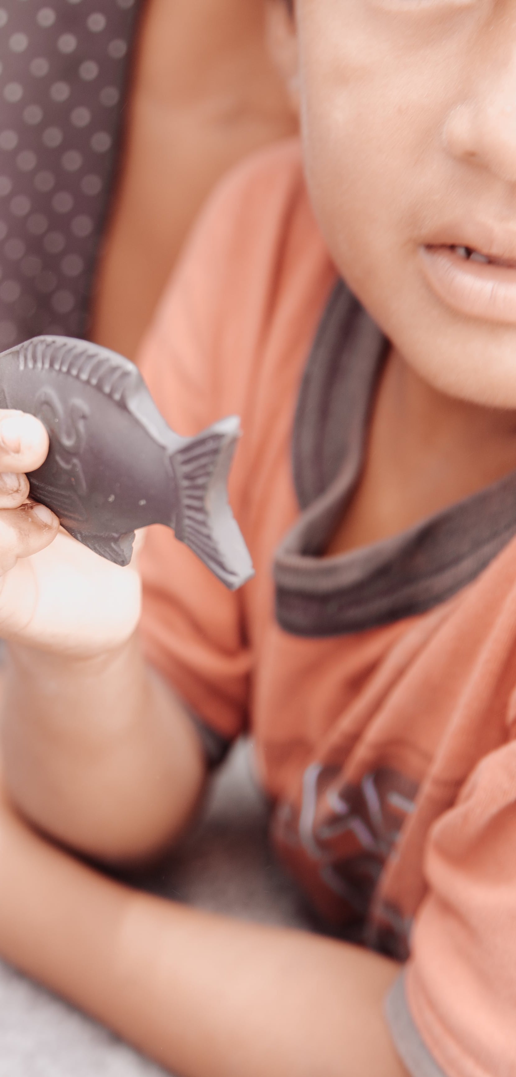 Child holding the Lucky Iron Fish in Guatemala