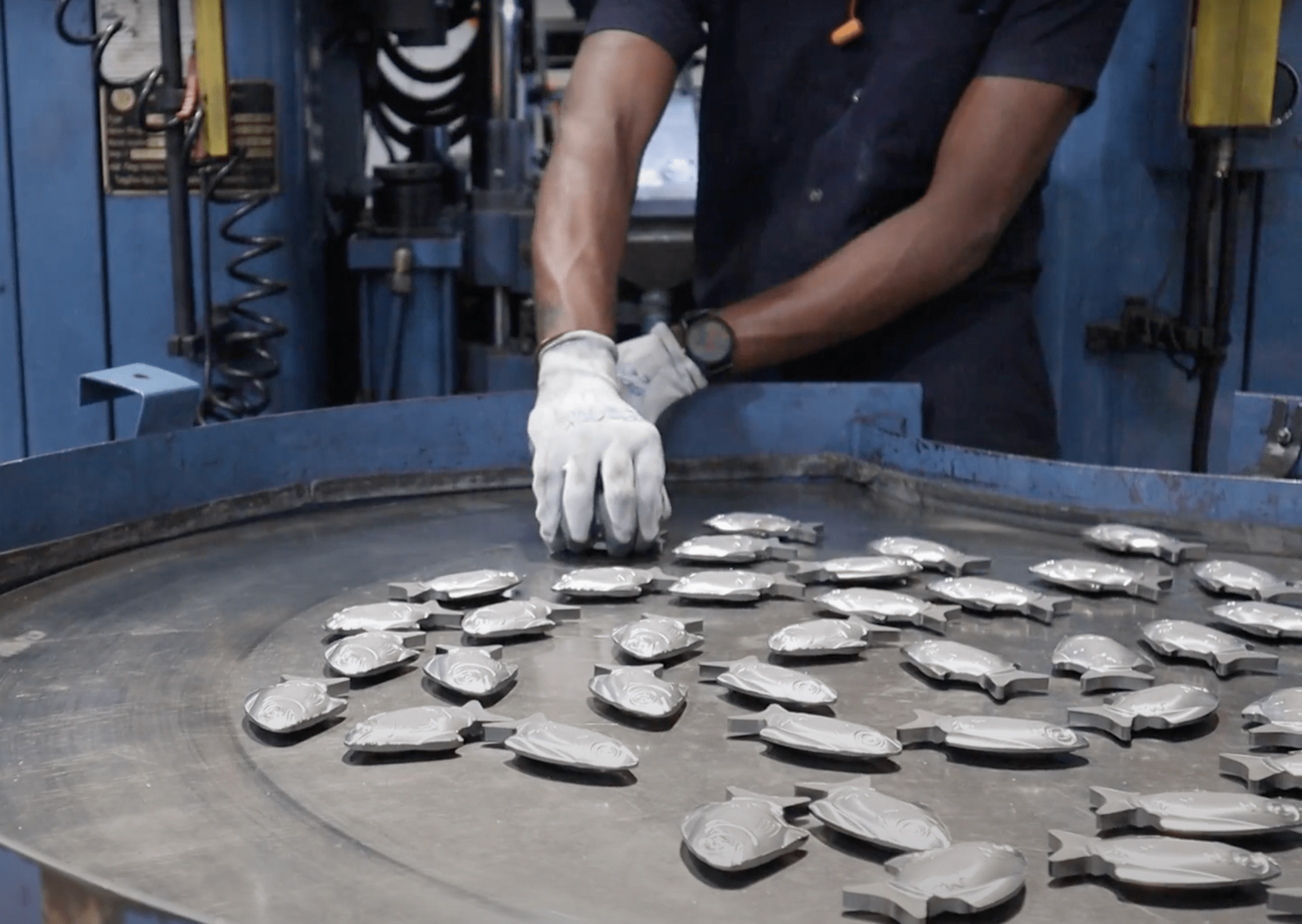 Quality factory employee handing Lucky Iron Fish product